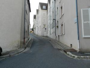 an empty alley with white buildings on either side at LE SEUIL in Chartres