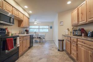 a large kitchen with wooden cabinets and a table at Beach House! in Clearwater Beach