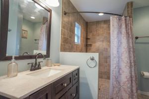 a bathroom with a sink and a shower at Beach House! in Clearwater Beach
