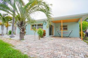 a house with a hammock in front of it at Beach House! in Clearwater Beach