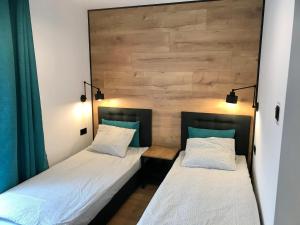 Postel nebo postele na pokoji v ubytování Apartamenty Chata u Rybaka
