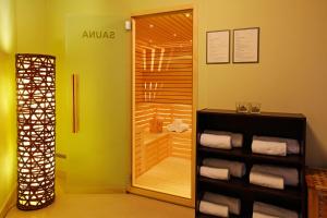 a walk in shower in a bathroom with towels at Boutique Hotel Bol in Bol