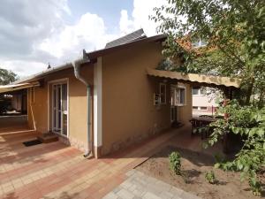 a house with a patio in front of it at Mini Villa in Hajdúszoboszló