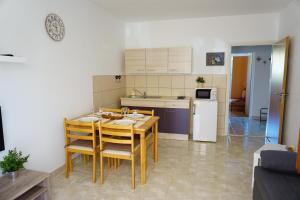 a kitchen and dining room with a table and chairs at Apartment Jelena in Fažana