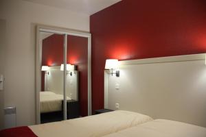 a hotel room with two beds and a mirror at VVF Pays Basque Sare La Rhune in Sare