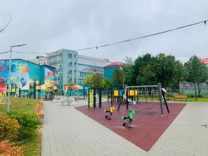 two children playing on a playground in a park at Perfect Place to Stay self check in-24h-NETFLIX-WIFI in Reşiţa
