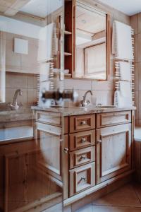 a kitchen with wooden cabinets and a sink at Das Verwall - finest serviced apartments in Lech am Arlberg