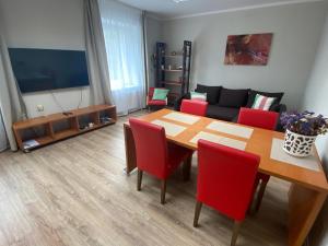 a living room with a table and red chairs at Family or Group Apartment in Silent Center in Riga