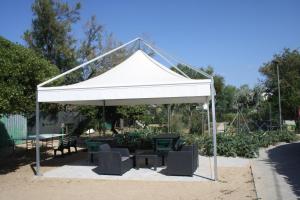 a white gazebo with chairs and a table at La Marina Bay in Vieste