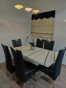 a dining room with a table and chairs at Homestay Dferry Jerantut Fully Aircond in Jerantut