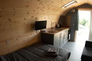 a small kitchen with a bed and a sink in a room at Wild Northumberland Glamping in Hexham