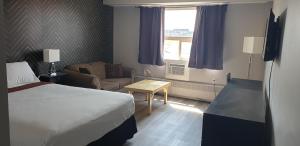 Postel nebo postele na pokoji v ubytování New Frontier Hotel