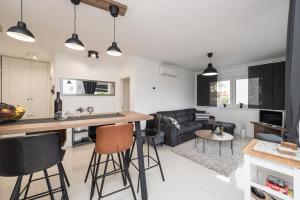 a kitchen and living room with a table and chairs at Apartman Enjoy Nin in Nin +13 photos