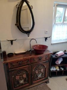 a bathroom with a sink and a mirror on the wall at Ochsenhof in Feuchtwangen +50 photos