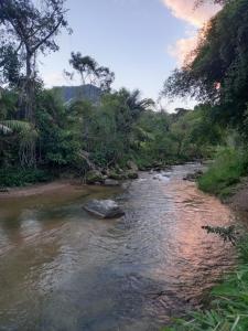 a river with a rock in the middle at Repousada Sana in Sana