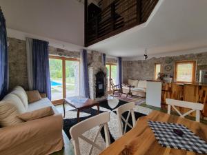 a living room with a couch and a table at Exo Log Cottage in Jezero