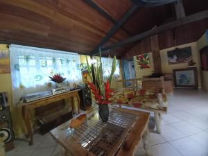 a living room with a vase of flowers on a table at Repousada Sana in Sana