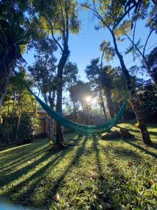 a hammock in a yard with trees at Repousada Sana in Sana