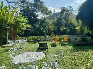 a group of chairs and a table in a yard at Repousada Sana in Sana