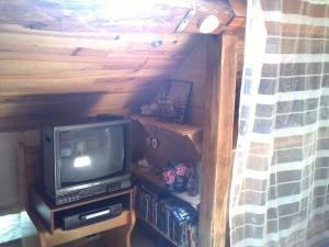 a small television sitting on a table in a room at Escale du Morvan in Sommant
