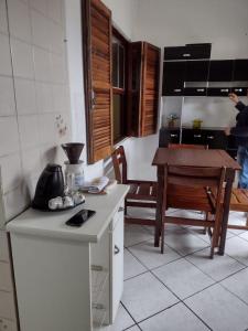 CASA NA PRAIA TEMPORADA في بيرويبي: مطبخ وغرفة طعام مع طاولة وكاونتر