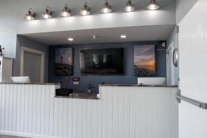 a room with a white counter with a tv on the wall at The Baywatch Resort in Traverse City