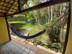 a hammock in a house with a garden at Repousada Sana in Sana
