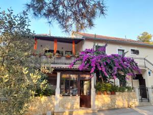 a house with flowers on the front of it at HOUSE-APARTMENTS ELA -MIRCA- FAMILY HOLIDAY in Mirce