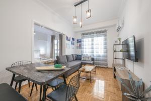 A television and/or entertainment centre at Athens Bright Suite by CloudKeys