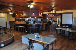a restaurant with tables and chairs and a bar at K7 Bed and Breakfast in Pahrump
