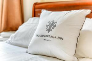 a pillow with the houstonagi inn on it on a bed at Hochelaga Inn in Kingston