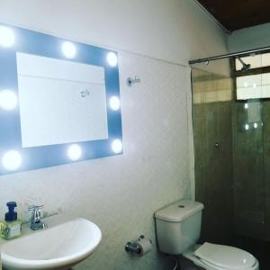 a bathroom with a toilet and a sink and a shower at Hostal spa casa de piedra con jacuzzi in Santa Rosa de Cabal +24 photos