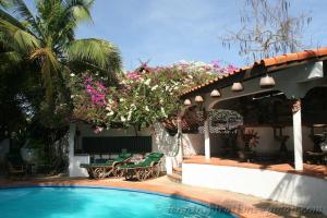 a house with a swimming pool and a patio at Secret Garden Chiangmai in San Kamphaeng