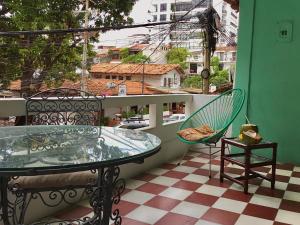 a balcony with a glass table and two chairs at My Lovely Loft Beach RG3 in Puerto Vallarta