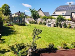 a garden with a small tree in a yard at A&K Guest House in Sandweiler
