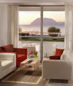 a living room with a view of the ocean at Airotel Achaia Beach in Patra