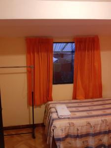 Rúm í herbergi á Hostal Ayllu
