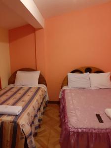 Rúm í herbergi á Hostal Ayllu