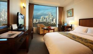 a hotel room with a bed and a large window at The-K Hotel Seoul in Seoul