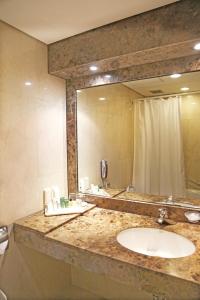 a bathroom with a sink and a large mirror at The-K Hotel Seoul in Seoul