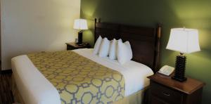 A bed or beds in a room at Stay Inn & Suites Montgomery