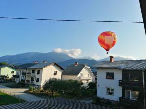 a hot air balloon flying over some houses at Freya in Lesce