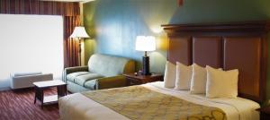 モンゴメリーにあるStay Inn & Suites Montgomeryのベッドとソファ付きのホテルルーム