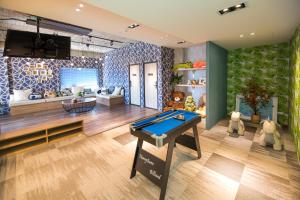 a living room with a pool table in it at Lovestar Lakeside Hotel - Stars Building in Nanwan