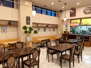 a dining room with tables and chairs in a restaurant at Sky Heart Hotel Hakata in Fukuoka