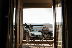 a room with a balcony with a view of the ocean at Fontana Hotel & Gastronomy in Budva