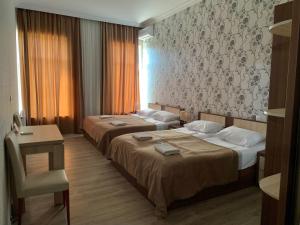 A bed or beds in a room at Hotel Red Bridge
