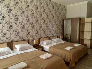 A bed or beds in a room at Hotel Red Bridge