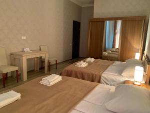 A bed or beds in a room at Hotel Red Bridge