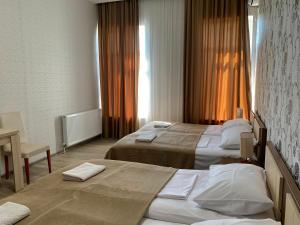 A bed or beds in a room at Hotel Red Bridge